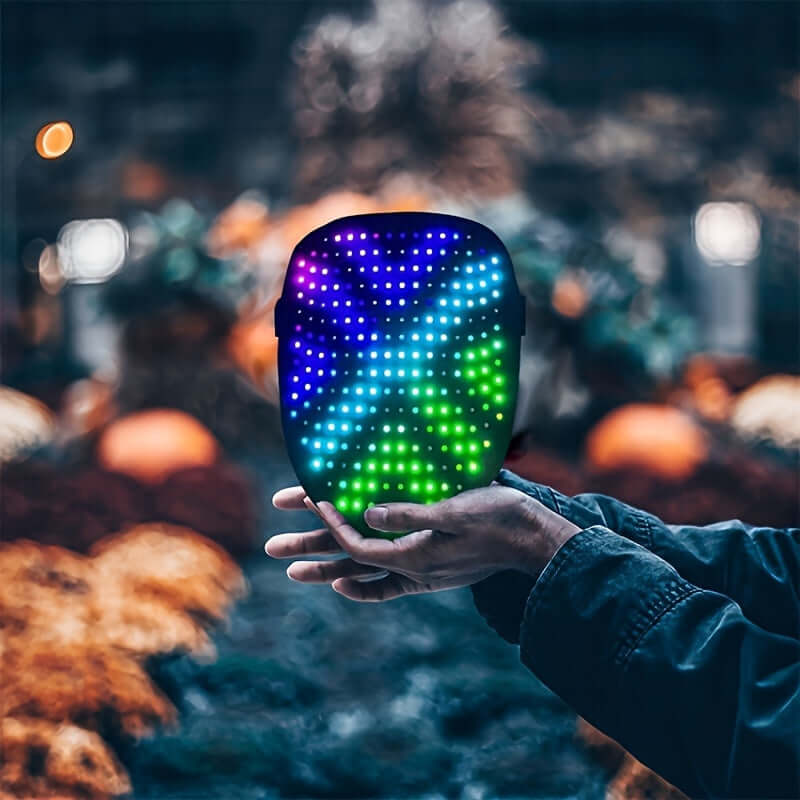 Vibrant LED gesture-sensing mask held in hands, perfect for raves and festivals. Suitable for events like Halloween and stage performances.