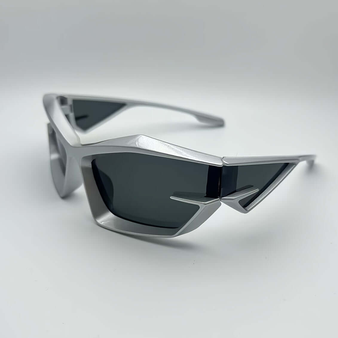 Modern silver polygonal rave glasses with anti-reflective lenses for outdoor climbing and hiking activities.