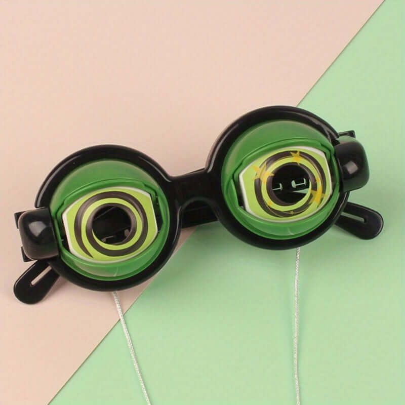 Novelty crazy eyes glasses with green lenses on pastel background, perfect for fun pranks and rave parties.