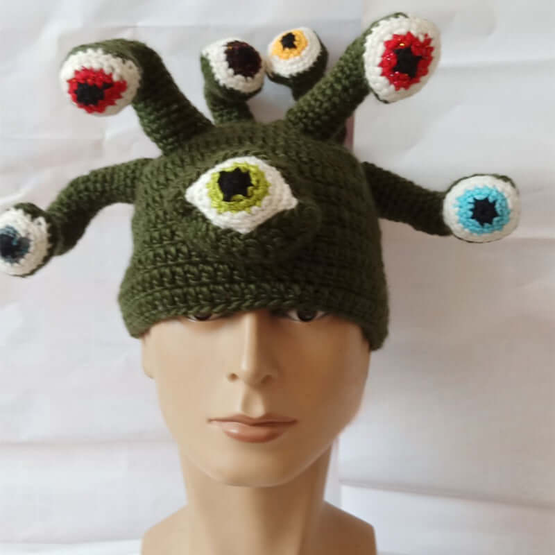 Handmade knitted festival hat with octopus eye design in green, featuring colorful eye stalks, perfect for quirky costumes and events.