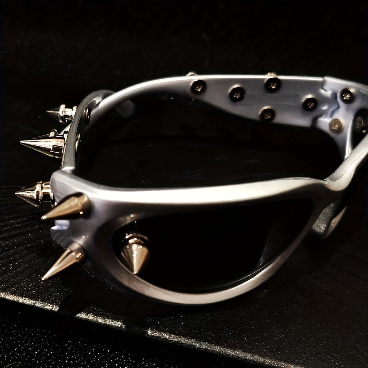 Cyberpunk cat eye glasses with metal rivet accents and anti-reflective lenses, ideal for rave parties and bold fashion statements.