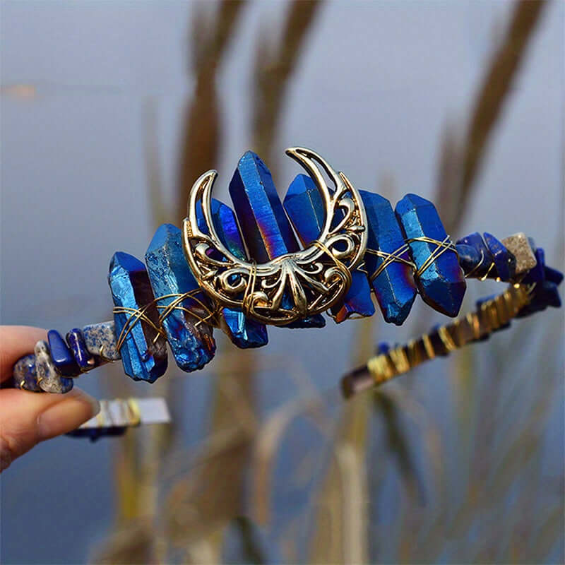 Elegant crystal headband with moon-shaped design, showcasing blue crystals and intricate metalwork, perfect for special occasions.