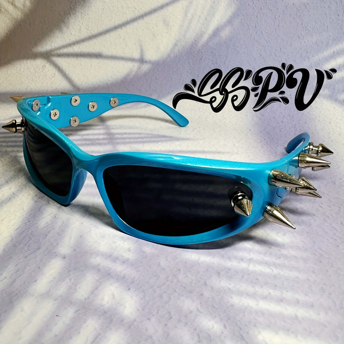 Blue cyberpunk cat-eye glasses with metal spikes and rivet accents, perfect for rave parties and bold fashion statements.