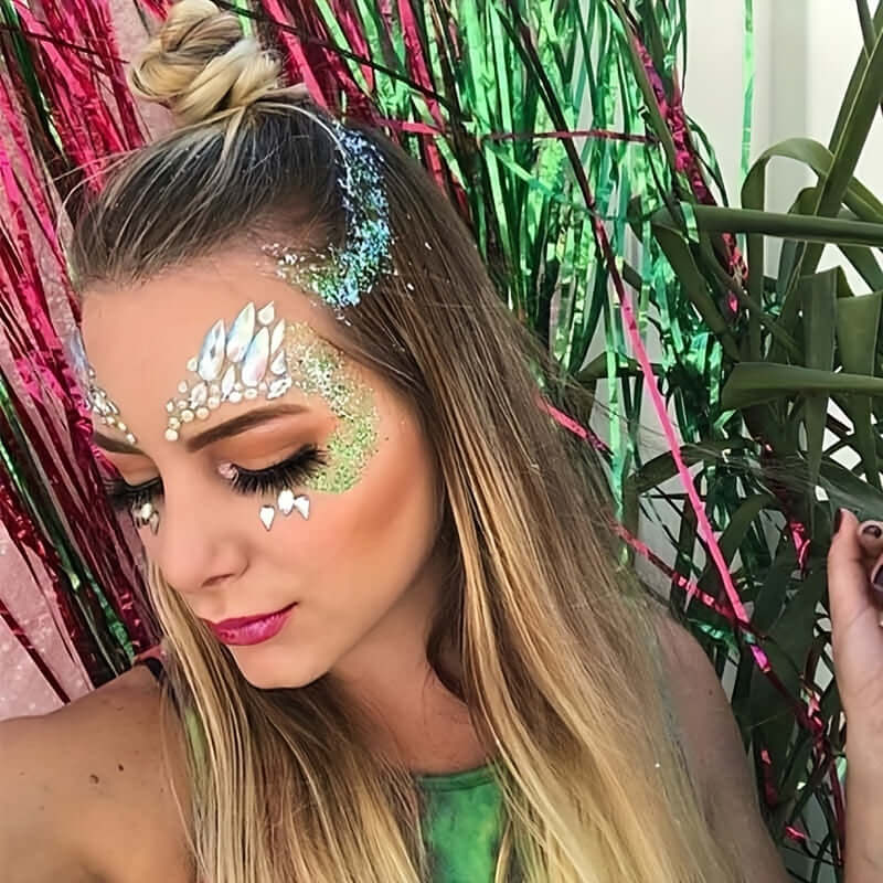 Woman wearing 3D crystal tattoo face stickers, perfect for masquerade parties, festivals, and special occasions, with green and pink decor.