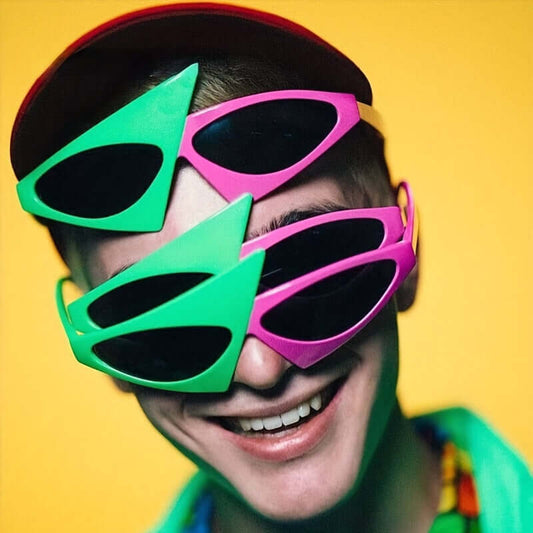 Person wearing vibrant green and rose red triangle-frame glasses with hip hop color block design, perfect for parties and events.