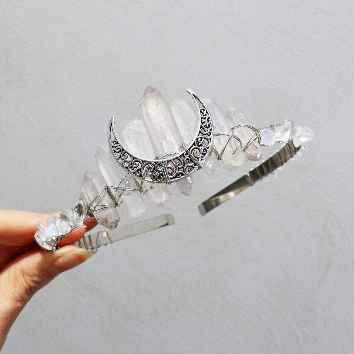 Elegant moon-shaped crystal headband for special occasions, featuring natural crystals in a boho-chic design.