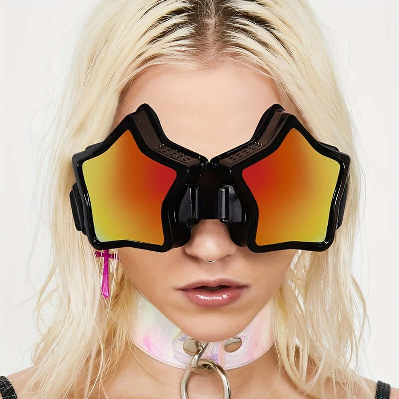 Woman wearing oversized mirrored Y2K rave glasses with star-shaped orange lenses and a choker, festival fashion.