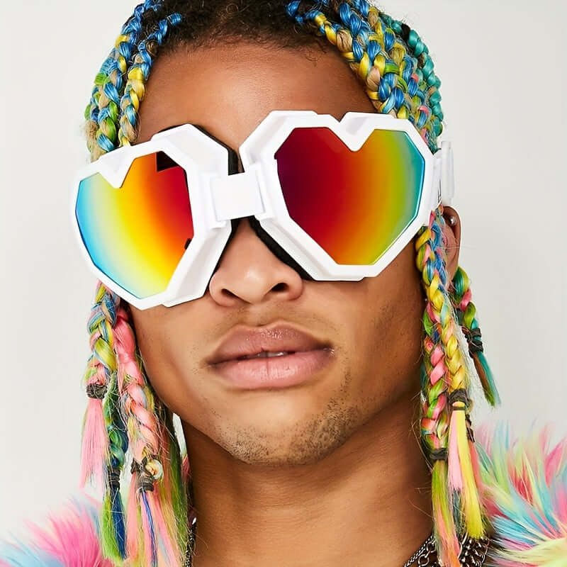 Person wearing oversized heart-shaped Y2K fashion glasses with mirrored rainbow lenses, suitable for rave and festival style.