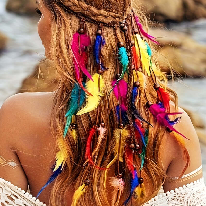 Woman wearing a rainbow hippie headband with vibrant faux feathers by the seaside.