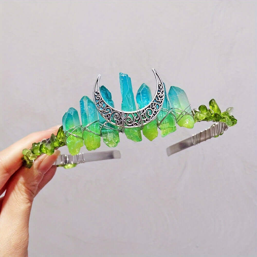 Elegant crystal headband featuring moon-shaped design, blue and green crystals, perfect for weddings and special occasions.