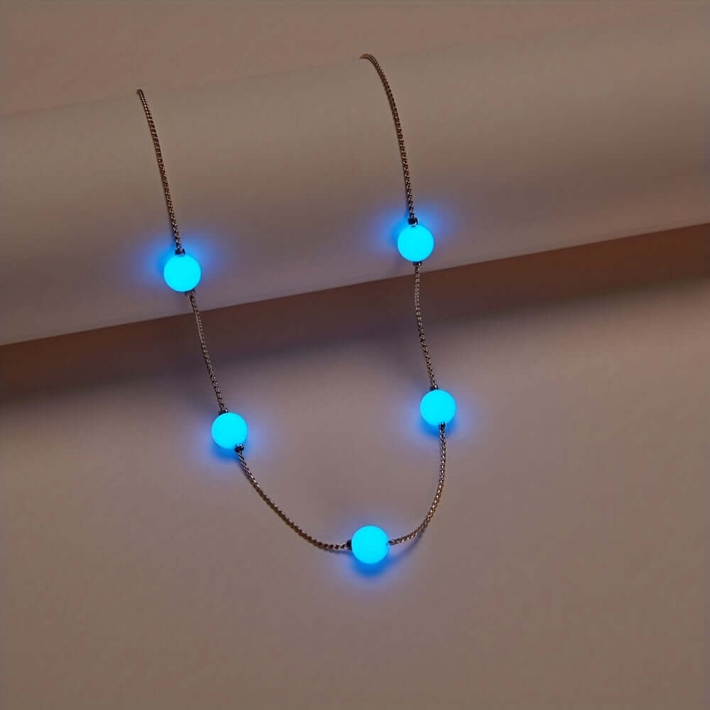 Glowing blue bead necklace showcasing luminous heart design, perfect for festivals and night events.