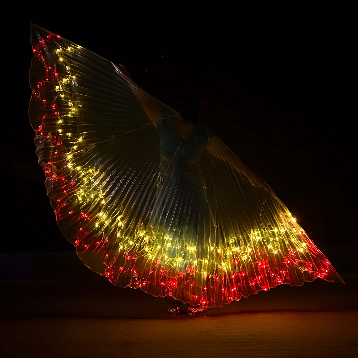 LED angel wings cape with vibrant red and yellow lights, perfect for festivals and performances, displayed in darkness.