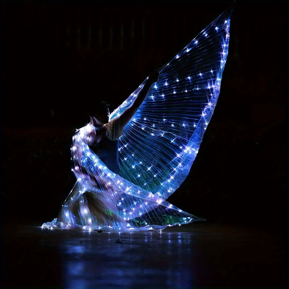 Person performing with LED butterfly wings showcasing bright 360-degree illumination at night.