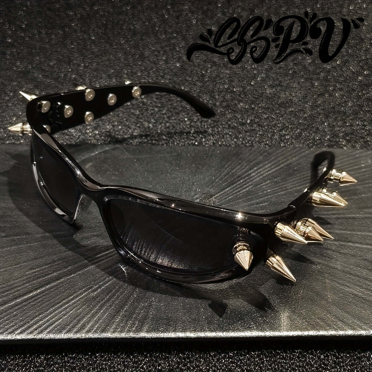 Cyberpunk cat-eye glasses with metal rivet accents on black plastic frame, perfect for rave fashion or party statement eyewear.