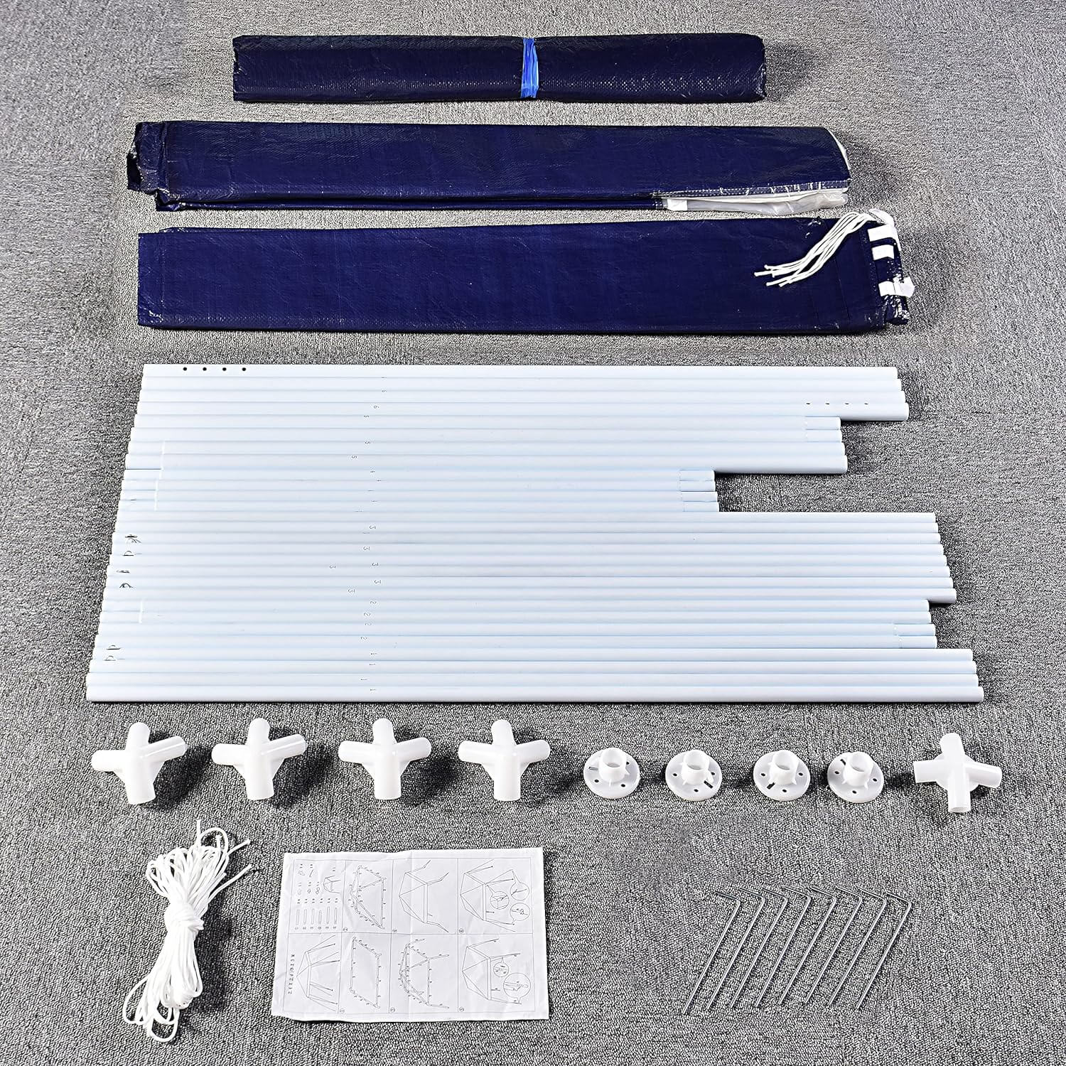 Gazebo assembly kit with powder-coated steel tubes, connectors, fabric cover, side panels, and setup instructions laid out.