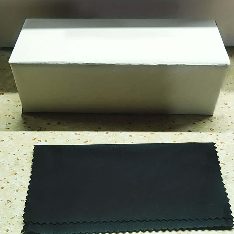 White storage box with a black cleaning cloth on a speckled surface, suitable for storing goggles or glasses accessories.