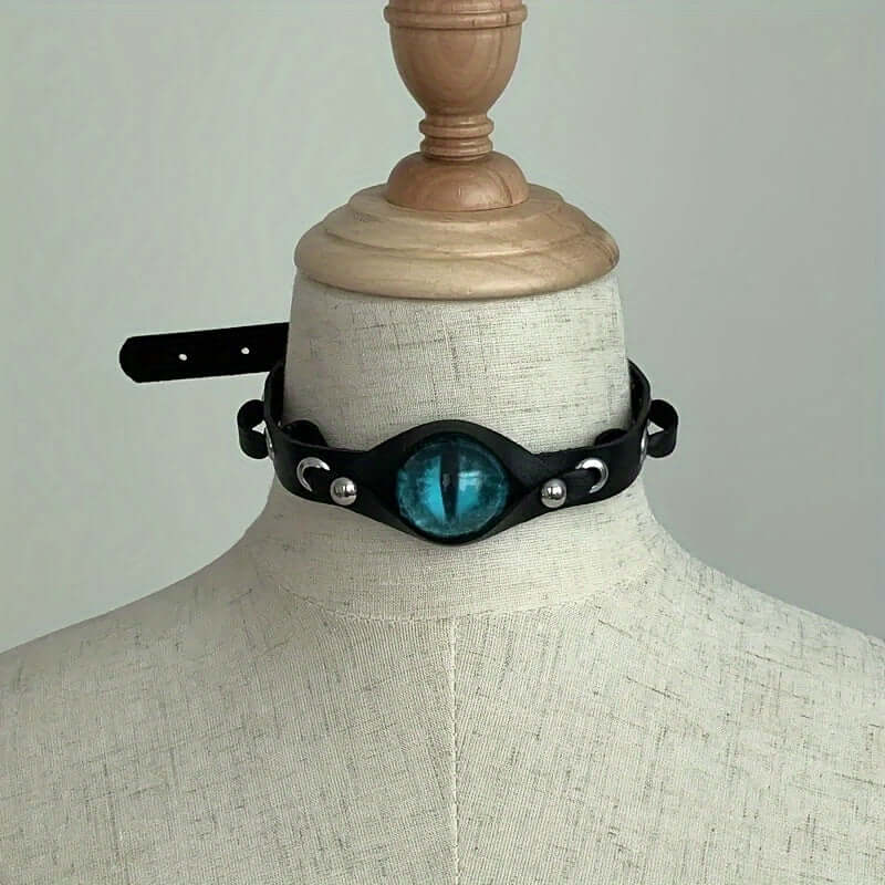 Y2K eye-shaped choker necklace on mannequin, black PU leather with blue eye pendant, trendy unisex punk fashion accessory.