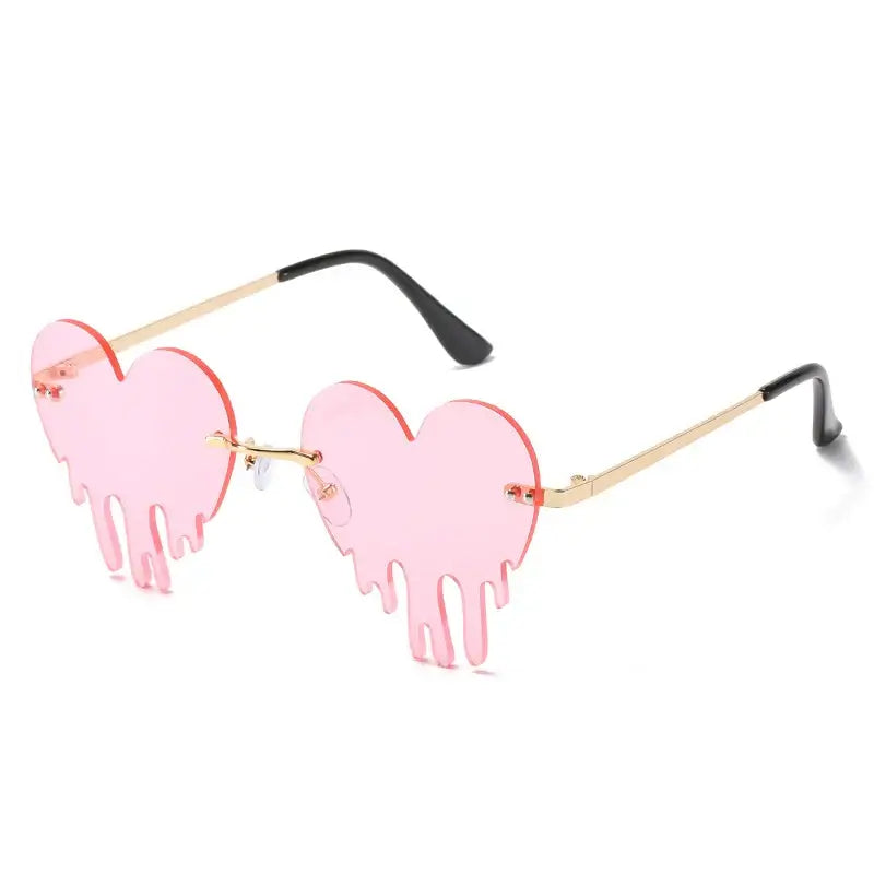 Pink heart-shaped rimless sunglasses with steampunk style and UV400 protection. Fashionable eyewear with unique tear design.