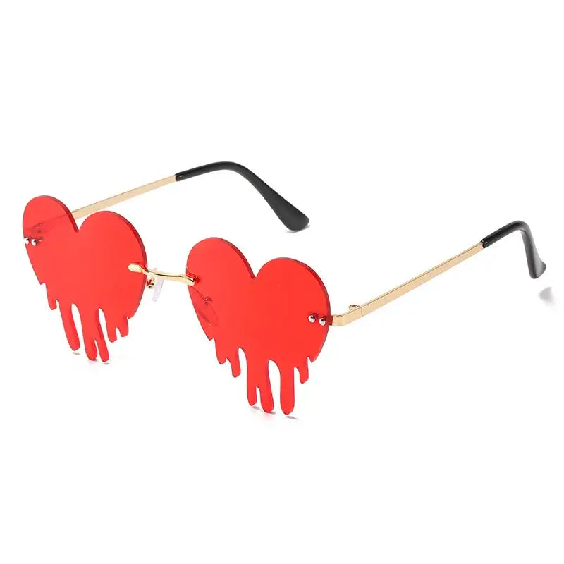 Red heart-shaped rimless steampunk sunglasses with UV400 protection and gradient lenses.