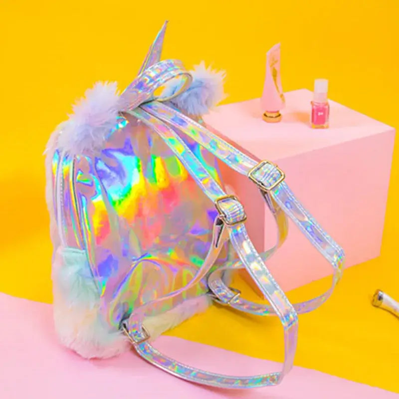 Holographic plush unicorn rainbow mini backpack with ears, colorful design for festivals and parties.