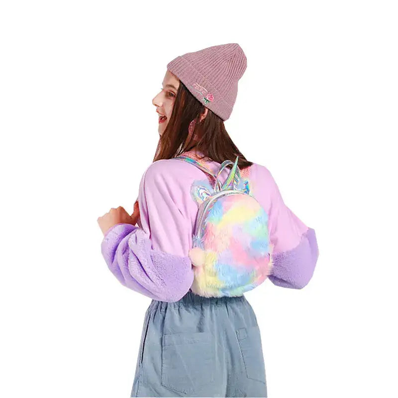 Woman wearing a Kawaii Unicorn Rainbow Mini Backpack with holographic plush design, perfect for festivals and parties.