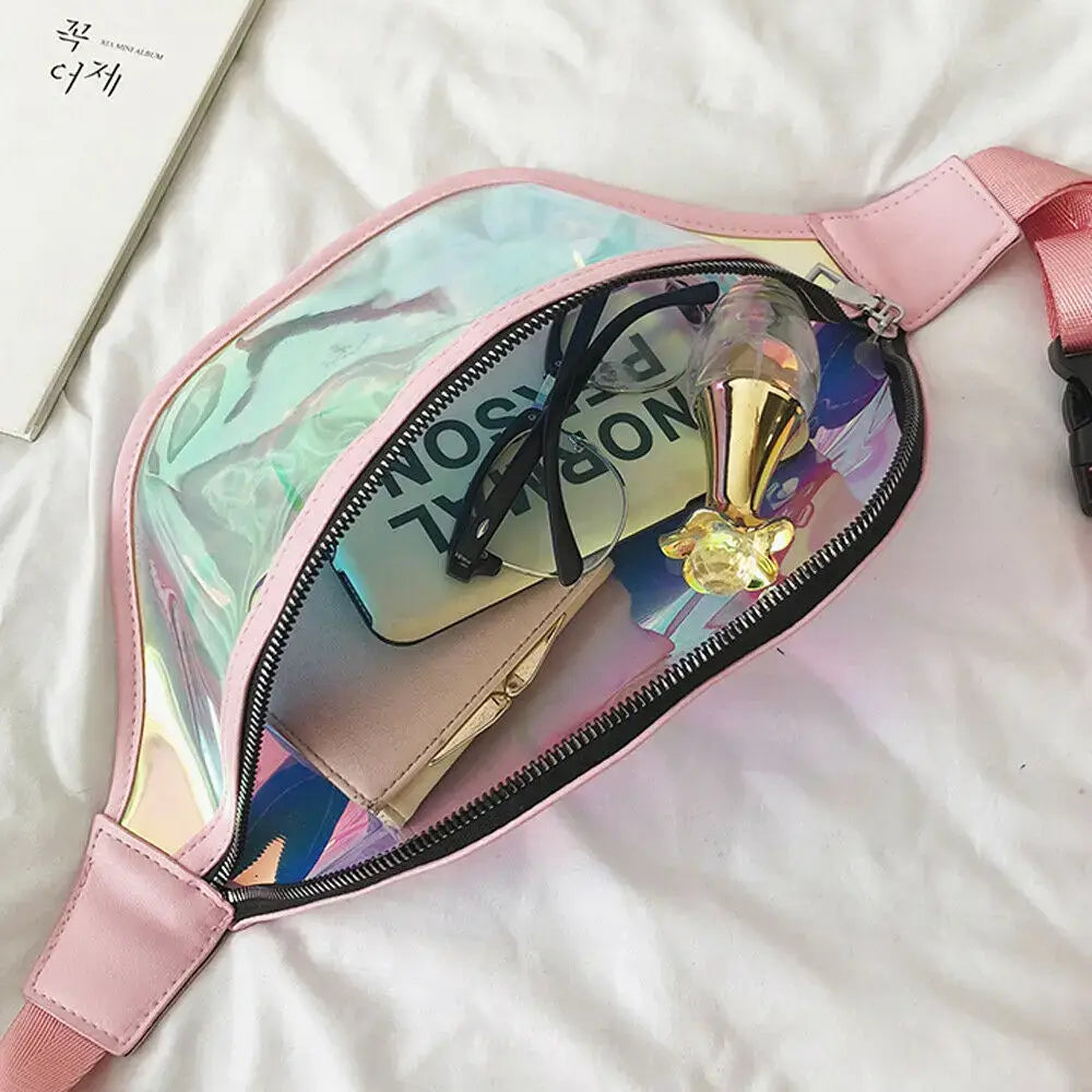 Open holographic PVC fanny pack with zipper, showing spacious interior with travel essentials, pink strap on white background.