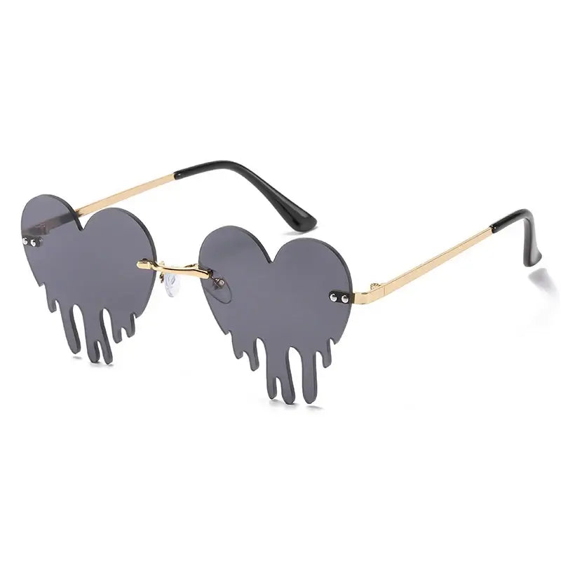 Heart-shaped rimless sunglasses in steampunk style with UV400 protection and gradient lenses, unique tear design.