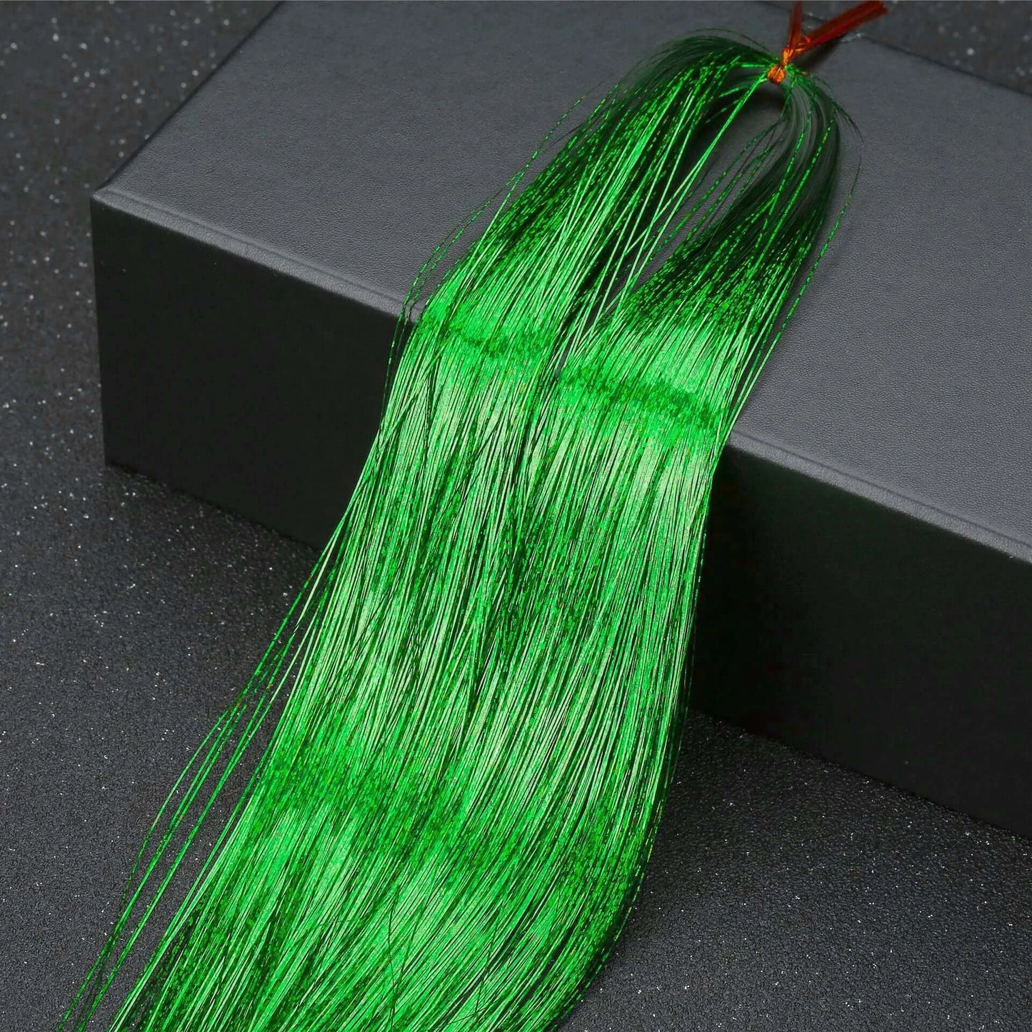 Vibrant green hair tinsel strands from the Rainbow Glitter Hair Tinsel Kit, perfect for parties and festivals.