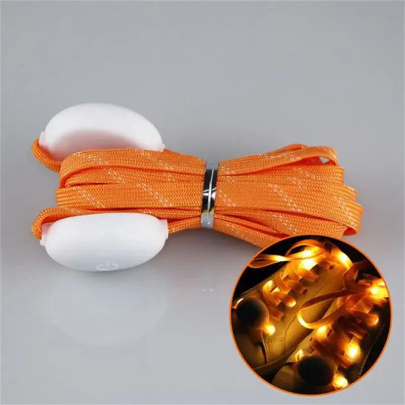 Orange LED light-up shoelaces with glowing effect, perfect for parties and night activities, shown in fast flash mode.