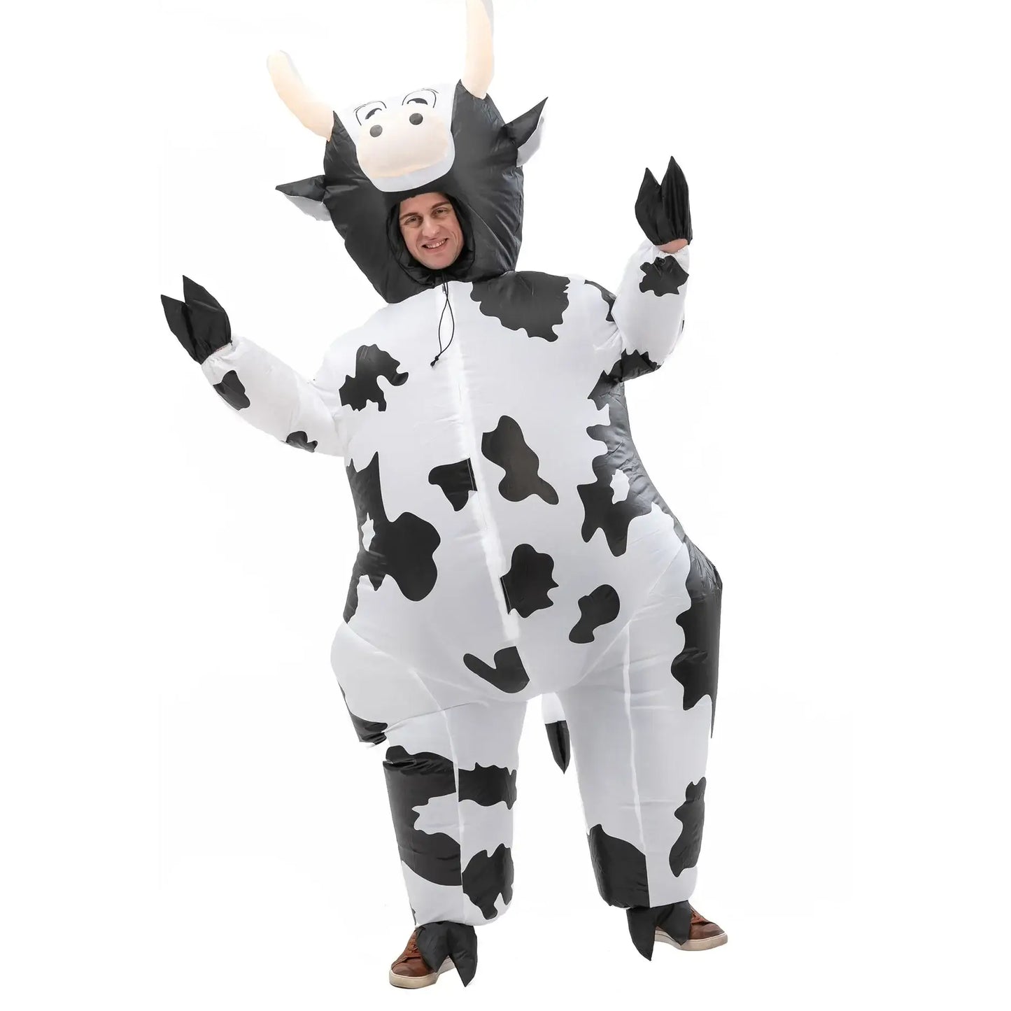 Adult wearing cow-themed inflatable costume at festival or party.