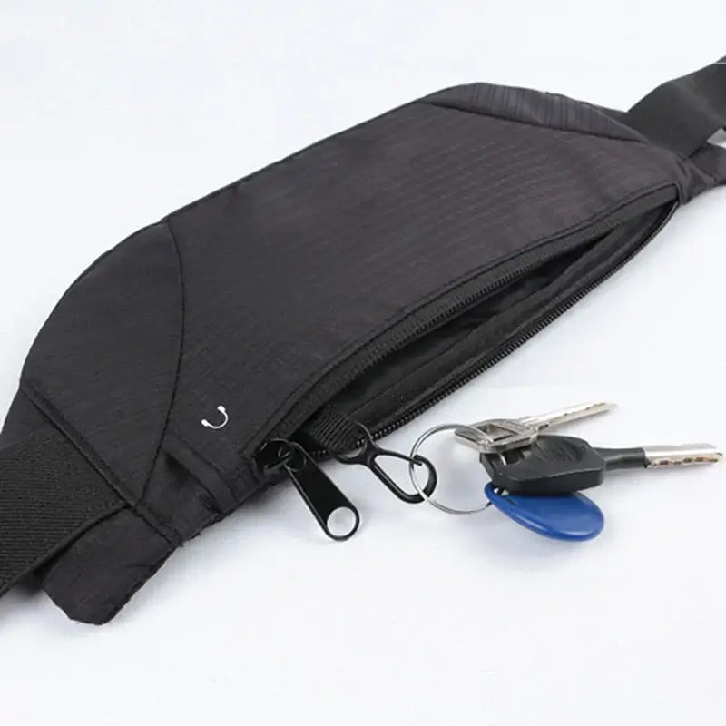 Black waterproof waist pack with keys attached, ideal for festivals and parties, featuring a phone pocket and durable polyester material.