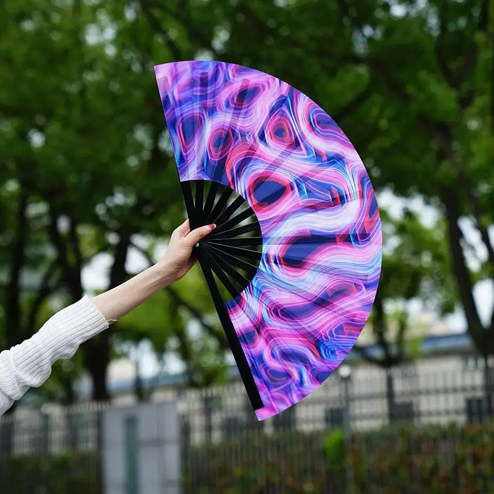 Vibrant gradient colorful reflective foldable rave fan held outdoors, perfect for festivals and parties.