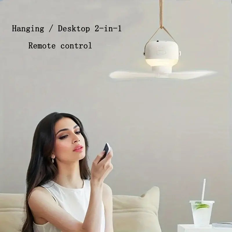 Woman using remote control for USB rechargeable mini ceiling fan with LED light, suitable for home and camping.