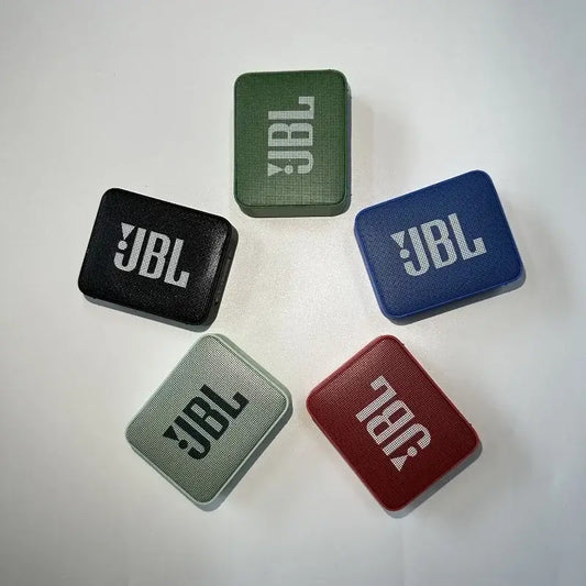 Five JBL GO 2 Bluetooth speakers in black, green, blue, grey, and red, showcasing the compact and portable design options.