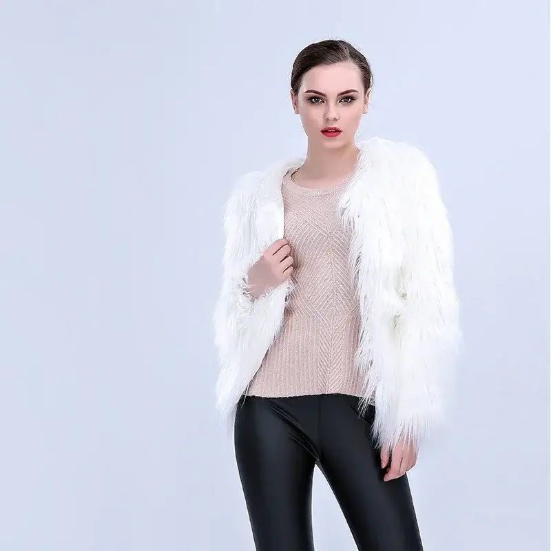 Woman wearing white faux fur coat with beige top and black leggings against a white background.