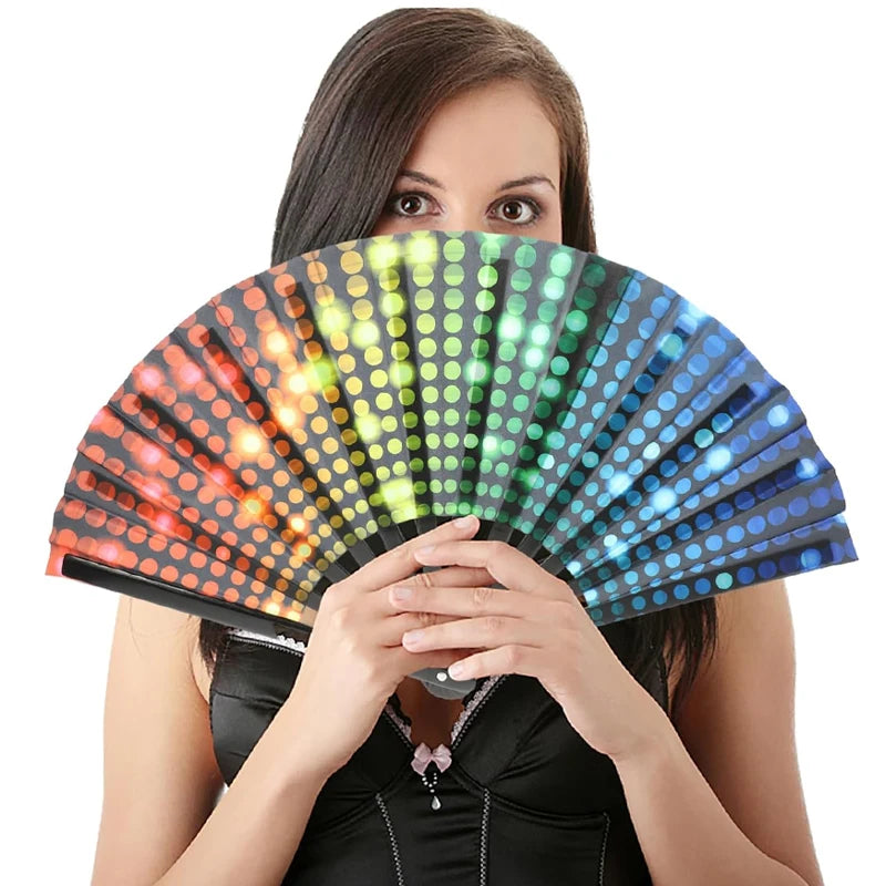 Woman holding vibrant gradient reflective foldable fan, ideal for festivals and dance events, showcasing its colorful dot pattern.