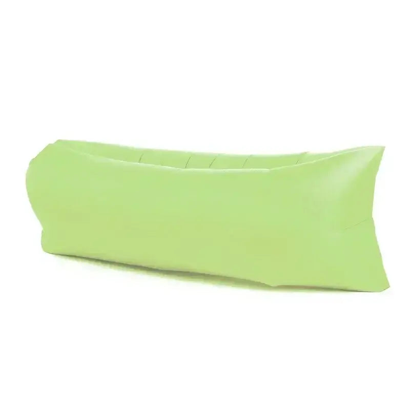 Green inflatable air lounger sofa for outdoor use, perfect for camping and beach, featuring lightweight, durable, and portable design.