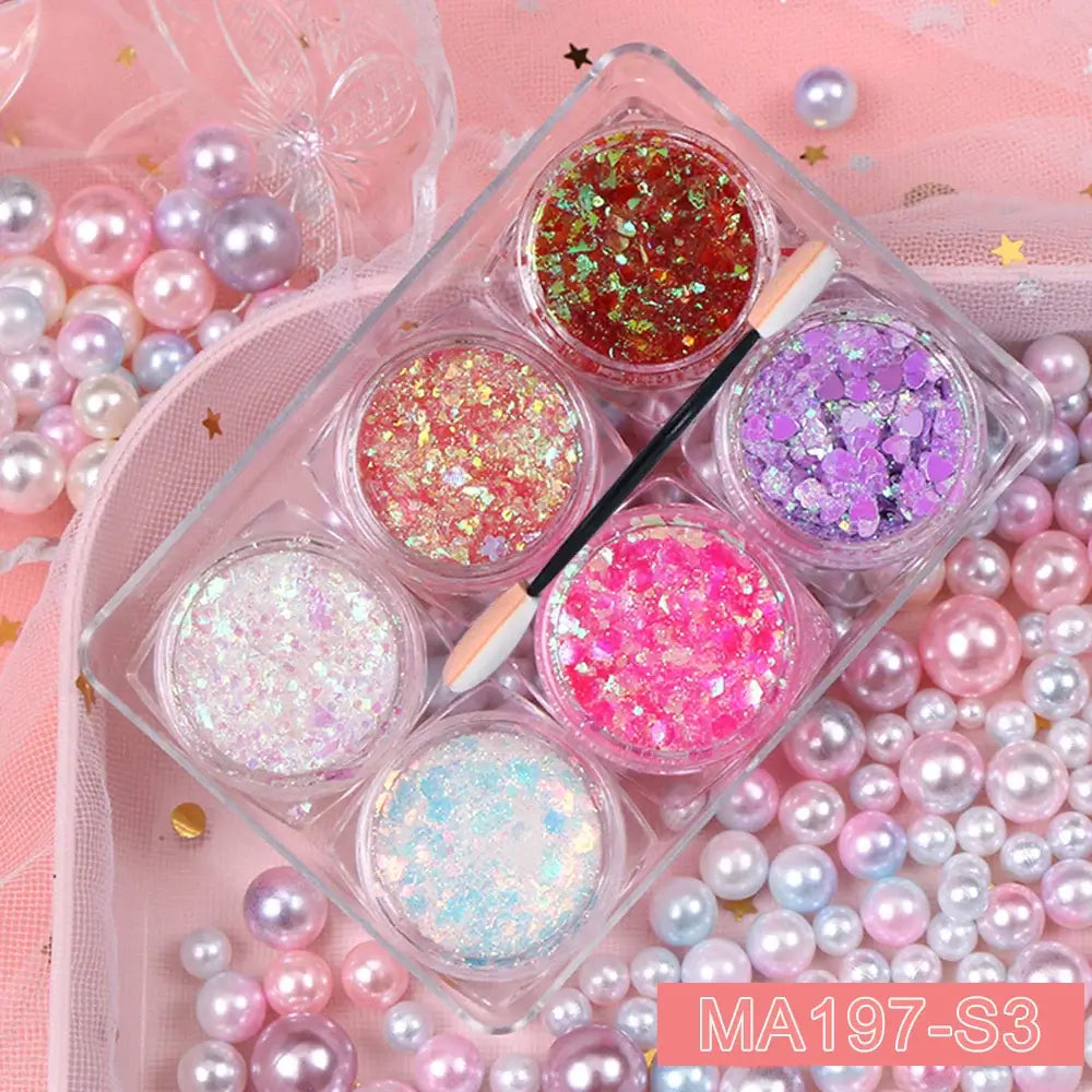 6 jars glitter gel set with hearts, stars, and moon sequins for festival makeup on face, hair, and body, surrounded by pearls.