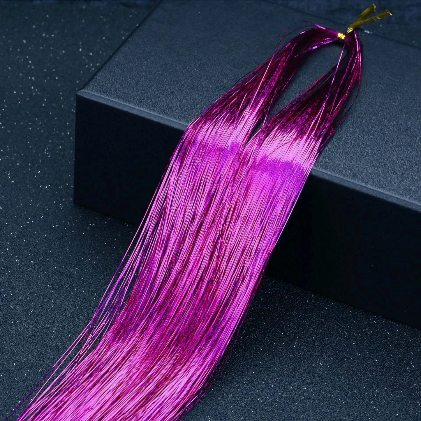 Rainbow Glitter Hair Tinsel Kit in vibrant magenta for parties and festivals, shown on a dark background.