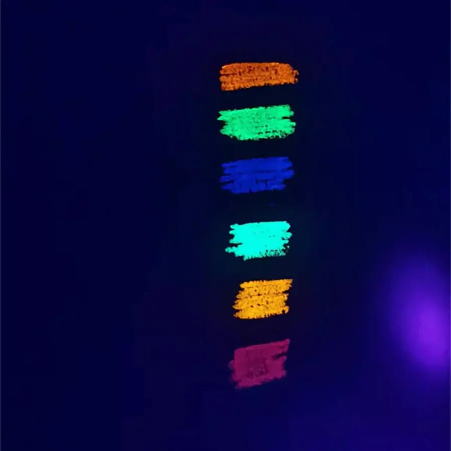 Neon body paint swatches in vibrant colors glowing under UV light, perfect for festival and rave makeup aesthetics.