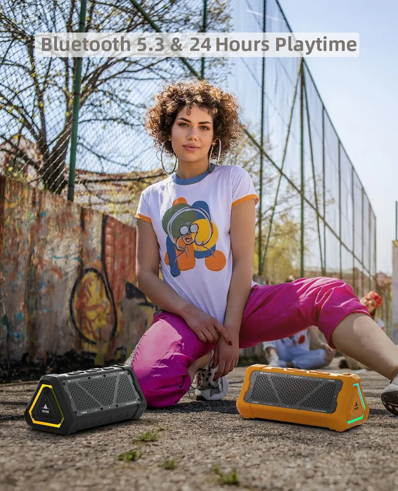 Person sitting outdoors with two MLOVE P3 Bluetooth speakers, showcasing vibrant design and Bluetooth 5.3 connectivity.