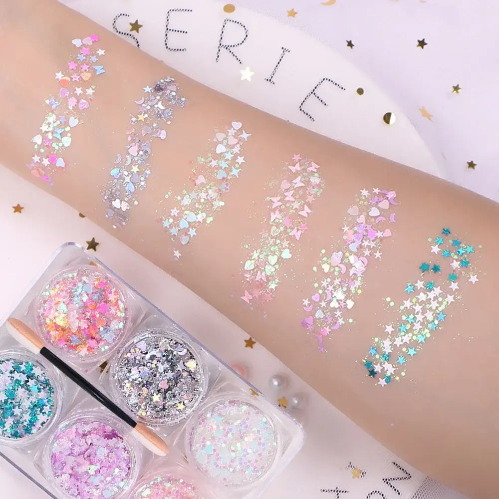 "6 Jars Glitter Gel swatches with hearts, stars, and moons sequins on arm for face, hair, and body festival makeup"