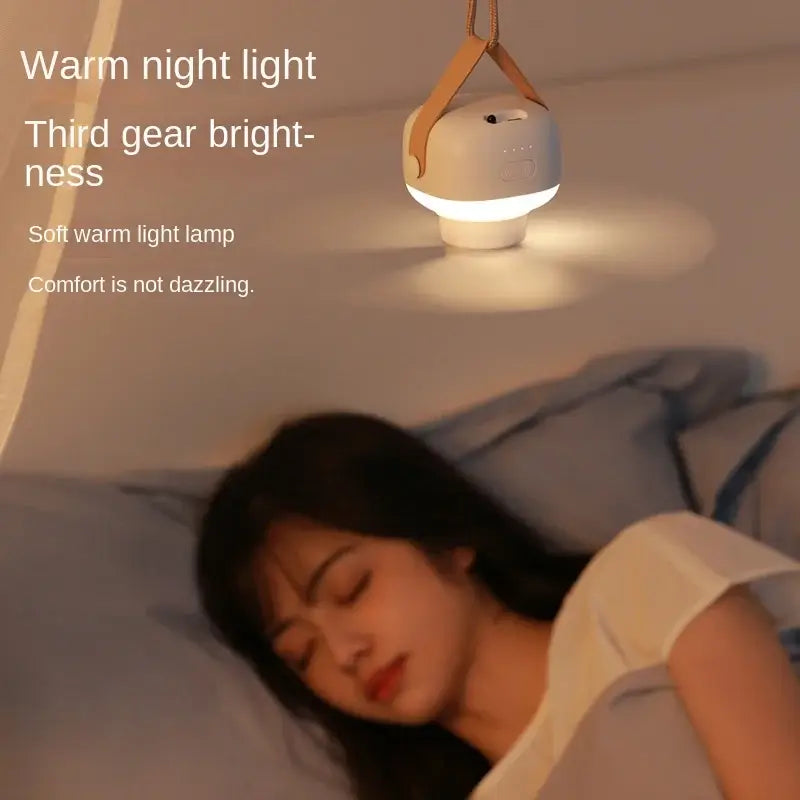 Woman sleeping under a portable mini ceiling fan with warm LED night light, adjustable brightness, ideal for comfortable rest