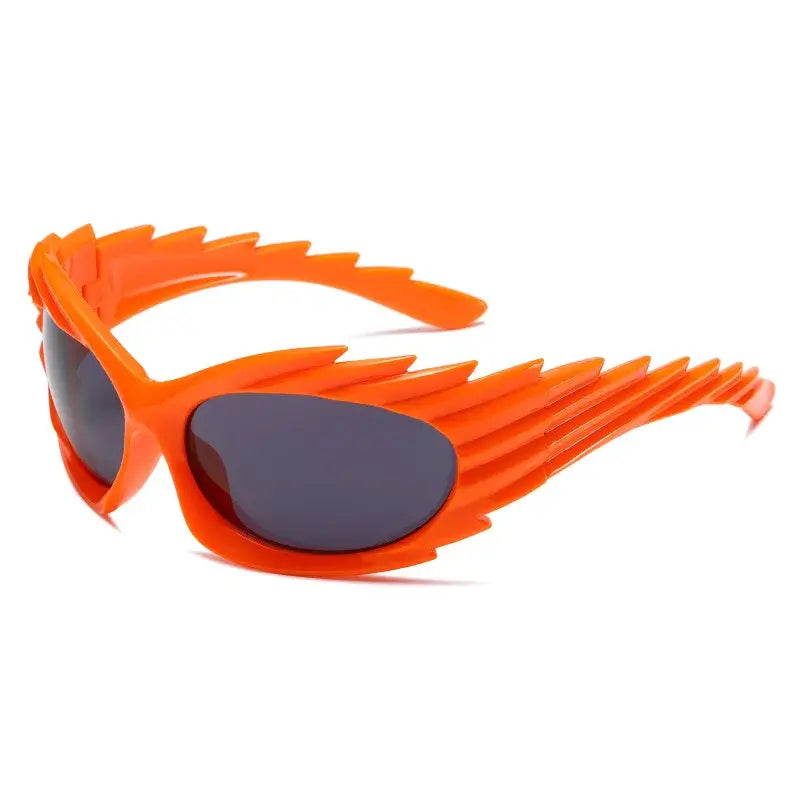 Y2K punk sunglasses in bright orange with a futuristic rimless design for a bold, edgy fashion statement.