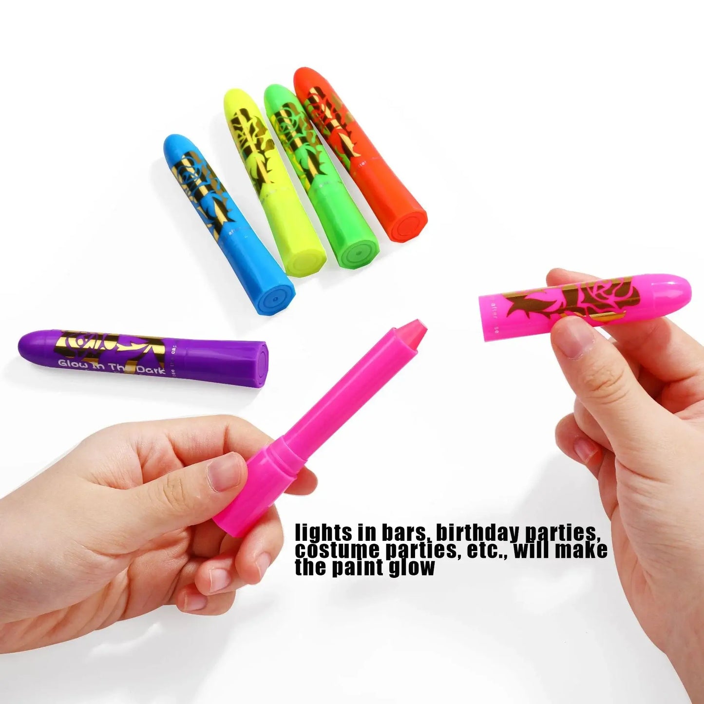 Person holding glow neon body paint sticks in various colors for festivals and parties.