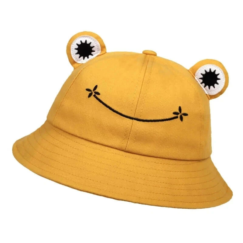 Yellow frog-themed bucket hat with playful face design, offering sun protection for outdoor leisure and casual style.