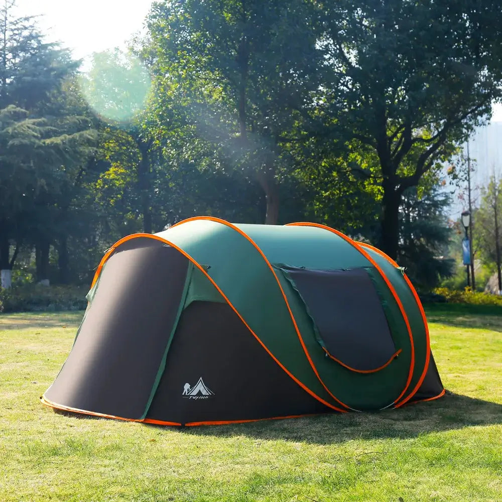 Ultralight green pop-up camping tent for 3-4 people, set up in a sunny grassy park, ideal for windproof and rainproof shelter.