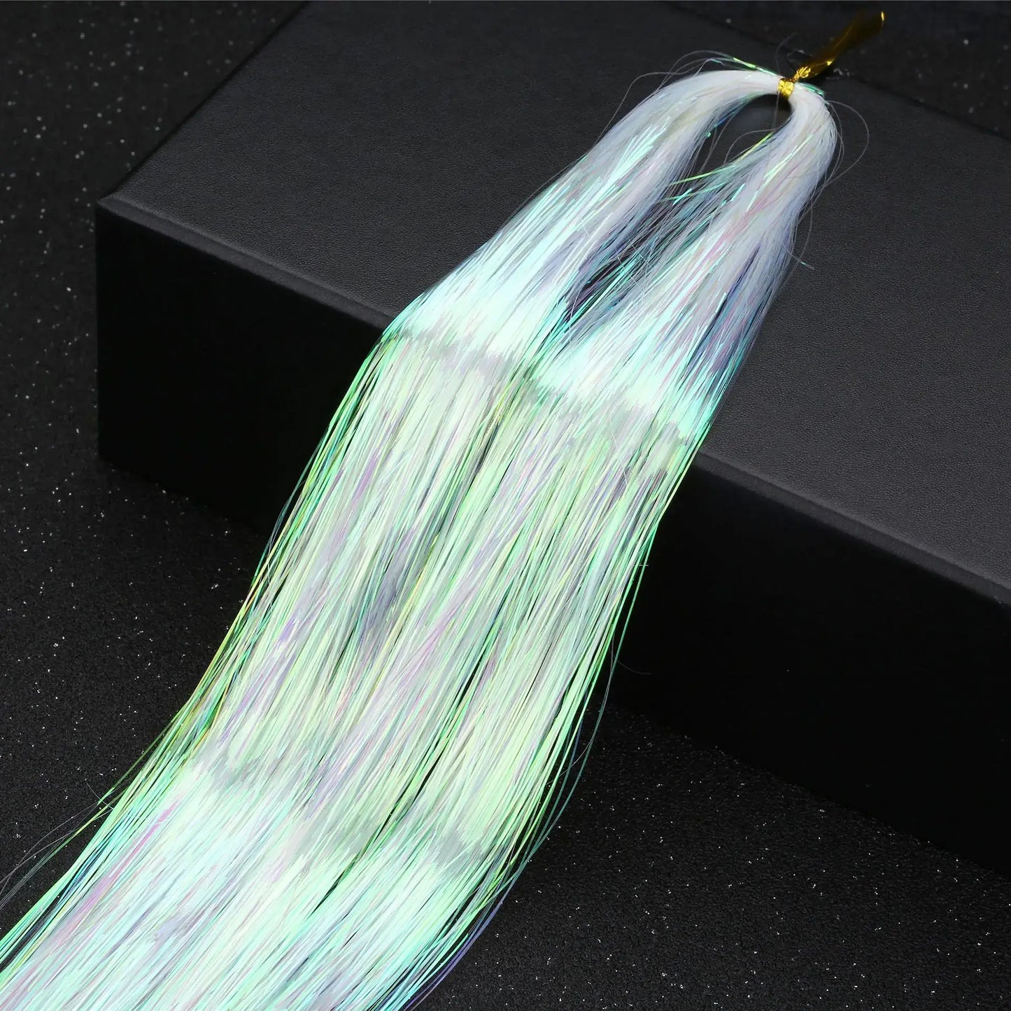 Rainbow glitter hair tinsel kit with 16 vibrant colors for party hairstyles, shown laid out on a black box.