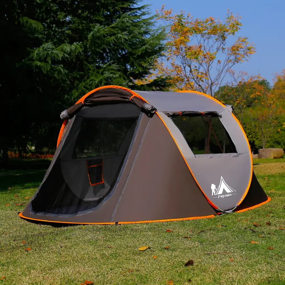 Ultralight automatic pop-up camping tent for 3-4 people in a park setting, showcasing windproof and rainproof features.