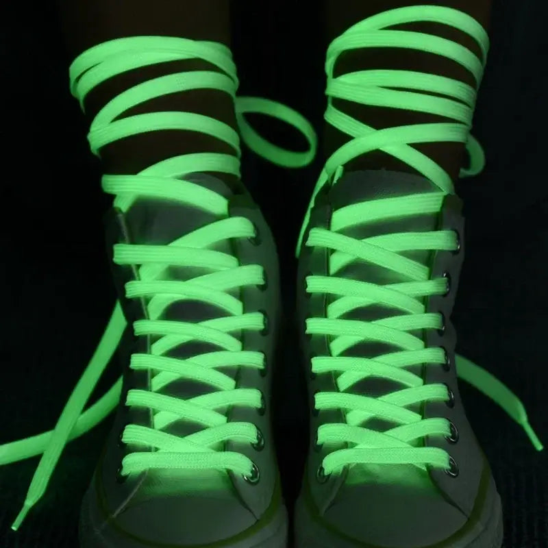 Glow-in-the-dark fluorescent shoelaces on sneakers, perfect for parties and night runs.